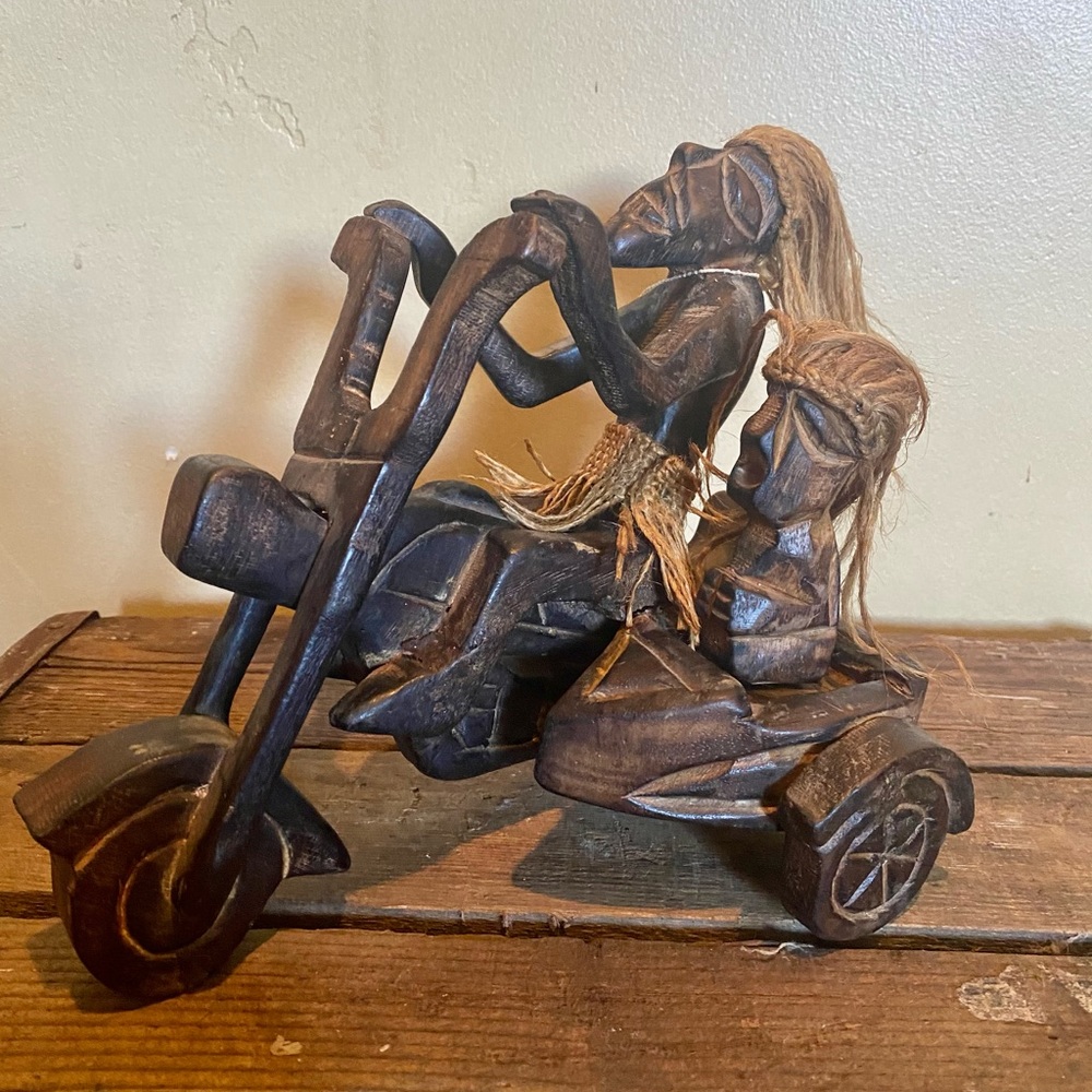 Wooden carved village people on motorcycle